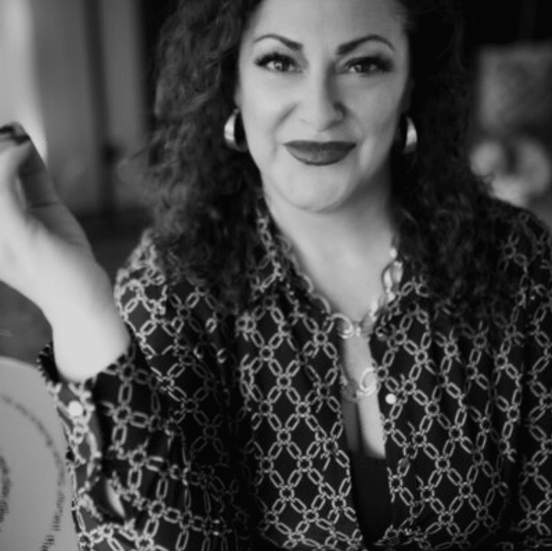 Black and white portrait of a smiling woman.