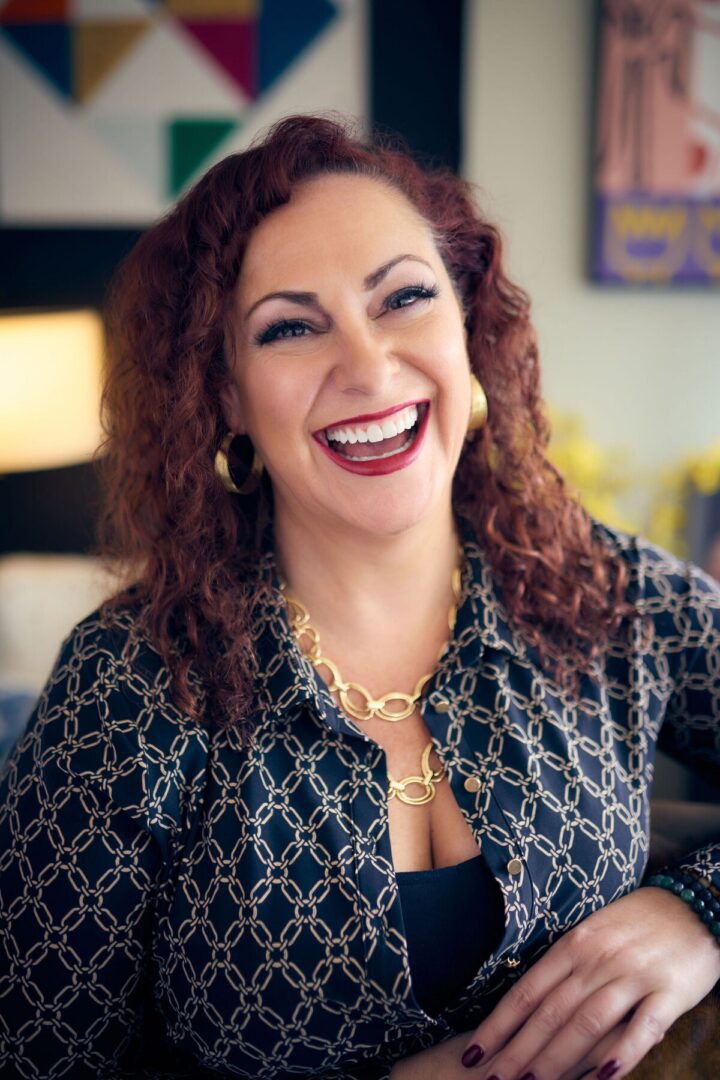 Joyful woman with red curls and necklace